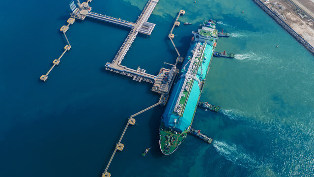 LNG Liquiefied Natural Gas tanker anchored in Gas terminal gas tanks for storage. Oil Crude Gas Tanker Ship. LPG at Tanker Bay Petroleum Chemical or Methane freighter export import