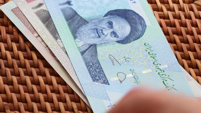 Iranian money. Converting larger denominations. Economic concept. Iranian rials and checks called toman. Iran currency IRR. Business background. Close up
