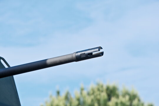 Automatic Weapon Barrel: Detailed Close-Up Views against Sky Background