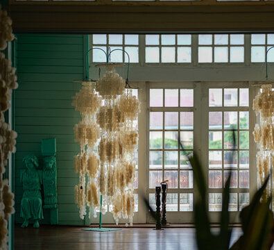 Elegant Capiz Shell Chandeliers by Window in Heritage Interior