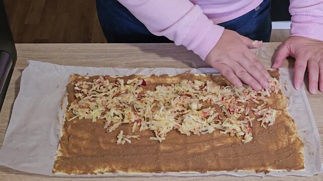 Woman preparing a sweet apple strudel dessert