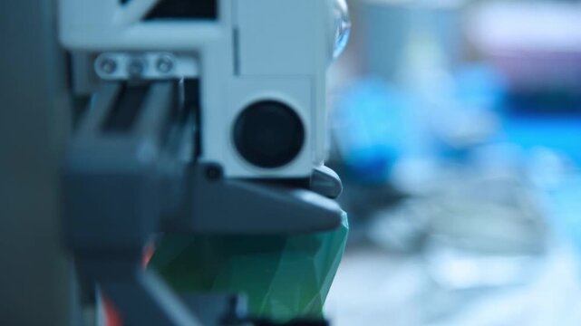 3D printer nozzle creating a green plastic object. Additive manufacturing process in a laboratory. Innovative industrial technology for rapid prototyping and production.