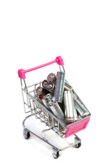 Batteries in a shopping cart on a white background, used batteries © AI-Valentin