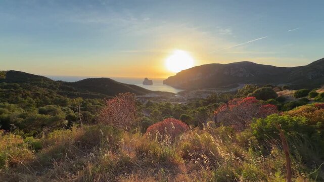 Breathtaking sunset overlooking Pan di Zucchero, coastal mountains, and a charming Sardinian town from the scenic road.