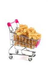 Uncooked pasta in a shopping cart on a white background © AI-Valentin