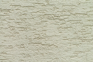 Fototapeta premium Rough beige plaster wall texture flat with cracks and horizontal ridges for construction, rebuilding, renovation and remodeling advertisement materials