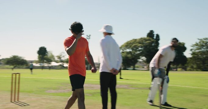 After marking run-up, asian man bowler conferring umpire, sprinting in bowling gauging length