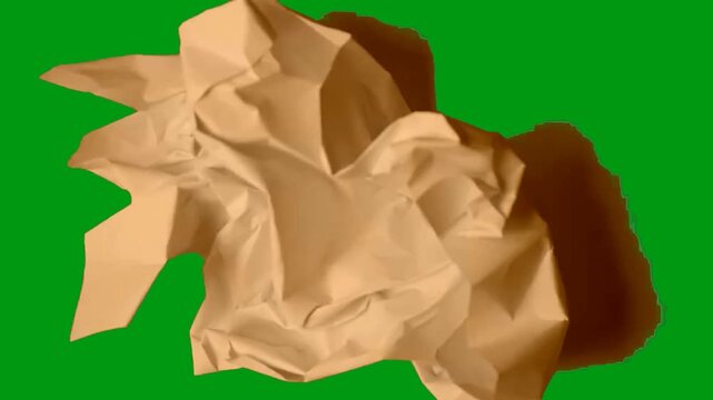 Ball of crumpled paper unfolding to form an organic frame layout over an isolated green screen chroma key background. clip footage design design graphics