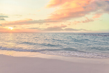 Fototapeta premium Beautiful tropical beach dreamy pink sunset. Soft pastel sky calm gentle ocean waves. Romantic paradise seascape glowing white sand. Inspire summer holiday travel backdrop, peaceful coastal evening