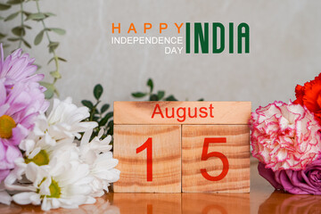 August 15. happy independence day of india. Wooden calendar with fresh flowers.