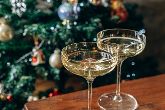 Champagne Glasses Toast in Front of Christmas Tree for Holiday Celebration and New Year Party