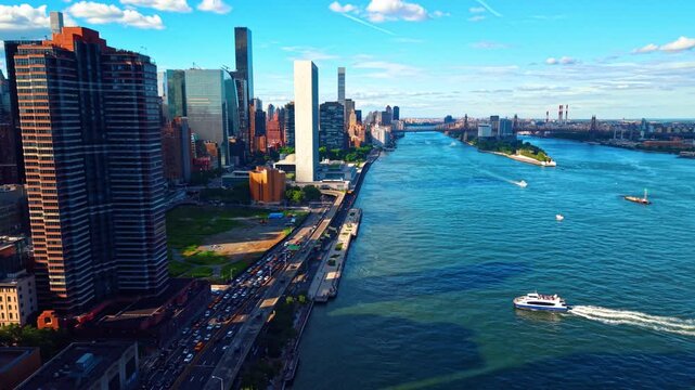 Cruise boat approaches the quay in New York City, USA. Lively traffic on the multi-lane highway along the river.