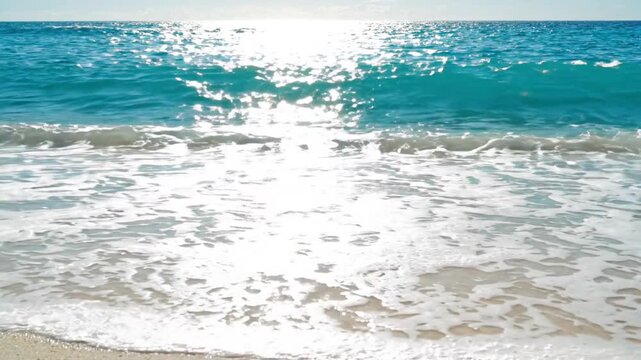 Sparkling turquoise ocean waves lapping onto a pristine golden sandy beach under bright sunlight, ideal for travel and relaxation themes