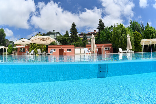 Half underwater photo of a swimming pool taken with fisheye lens