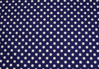Close up of classic polka dot pattern cotton cloth. Texture of blue fabric with white polka dots background.  © Eriko Ochiai