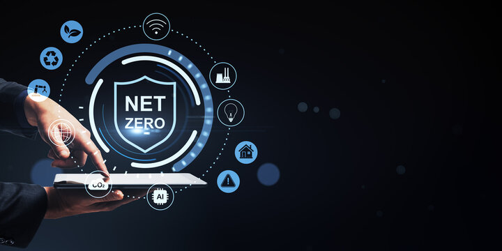Net zero sustainability interface with hands holding digital tablet surrounded by environmental icons on dark abstract background conveying clean energy concept.