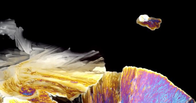 Extreme Macro video of abstract microscopic crystal formation growing under polarized light