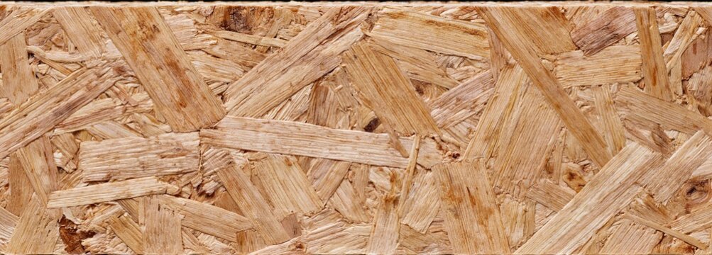 Close-up of eco-friendly chipboard showcasing natural wood grain, ideal for sustainable interior projects and renovations.