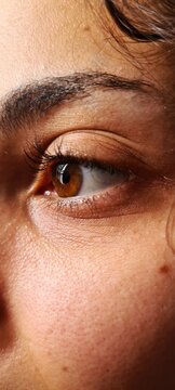 Natural brown eye close-up with detailed eyelashes and skin texture