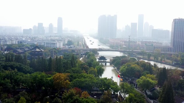 Hazy aerial view of Suzhou canal, classical Chinese garden and modern skyline in Suzhou, Jiangsu, China
