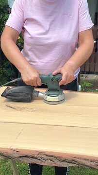Woodworker Refining Tabletop in the garden
