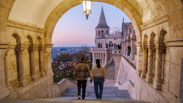 Strolling hand in hand at twilight near the fairy-tale Fishermans Bastion in Budapest Hungary