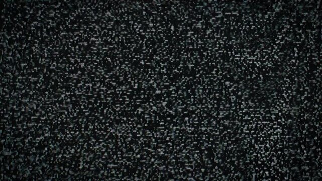 A full frame view of chaotic black and white television static noise flickering rapidly on a screen. Concept of signal loss, technical difficulties, and retro analog distortion.