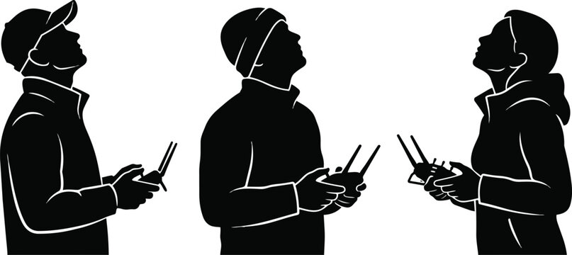 Three black vector silhouettes of people looking up while operating remote control devices for drones in a simple minimalist style isolated on a white background