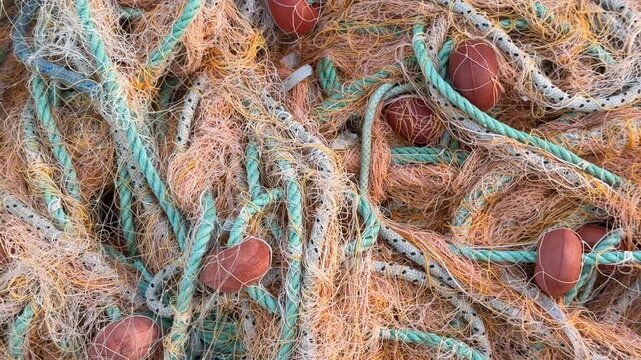 Colorful fishing nets and floats tangled together creating a textured maritime background
