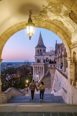 Naklejka premium Couple walking hand in hand at Fishermans Bastion in Budapest during sunset