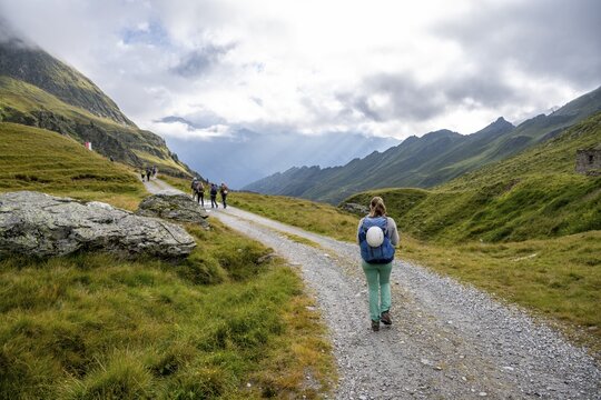 Hiker on a forest path near the Martalm, Lazzacher Tal, Seven Lakes Hike, Stubai Alps, near Ridnaun, South Tyrol, Italy