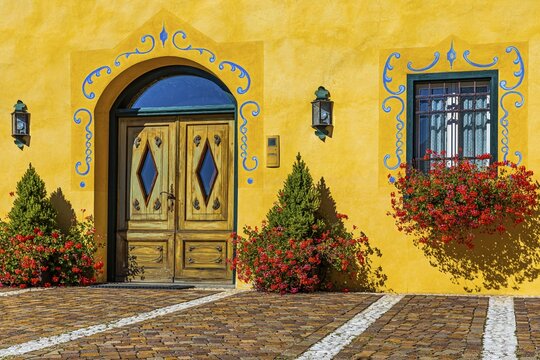 Ornate and flower-decorated house entrance, Cortina dAmpezzo, Dolomites, South Tyrol, Italy