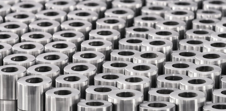 Seamless pattern of numerous metallic cylindrical tubes viewed from above industrial context metal cylinders supply chain industrial background material science heavy industry industrial