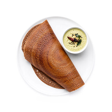 Traditional ragi dosa served with coconut chutney on white plate. Ai generative