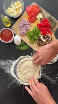 Step by step preparation of a sourdough pizza with Greek feta, egg, padron pepper and shallot