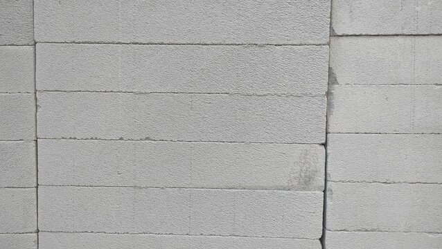 A neat stack of gray lightweight concrete blocks. Concept for modern construction, building material, masonry work, renovation, industrial architecture, and structural home improvement
