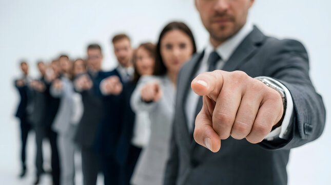 Business leader pointing at viewer in professional office setting with confident team