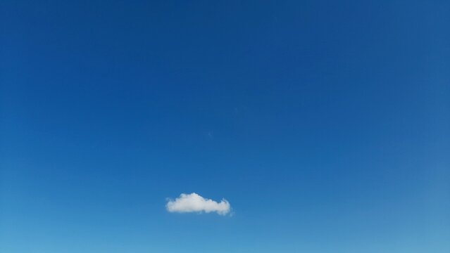 Small Single White Cloud in a Clear Deep Blue Sky