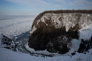 Furepe Waterfall and drift ice coastline with lighthouse in Shiretoko, Hokkaido / 知床のフレペの滝と流氷の海岸線と灯台 © warapin