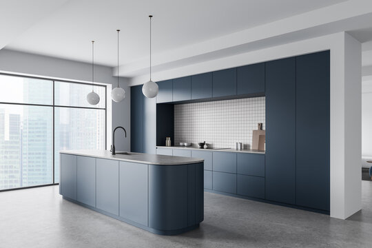 Modern interior kitchen with sleek blue cabinetry, large island design, pendant lighting and panoramic window city view creating elegant space. 3D Rendering