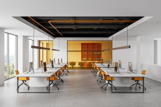 Modern open office interior with rows of desks, orange chairs, computers, large windows and meeting room in bright contemporary workspace. 3D Rendering