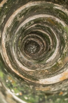 Inside an old stone well with moss and weathered circular walls