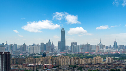 Obraz premium City Skyline With Tall Modern Skyscraper Under Clear Blue Sky