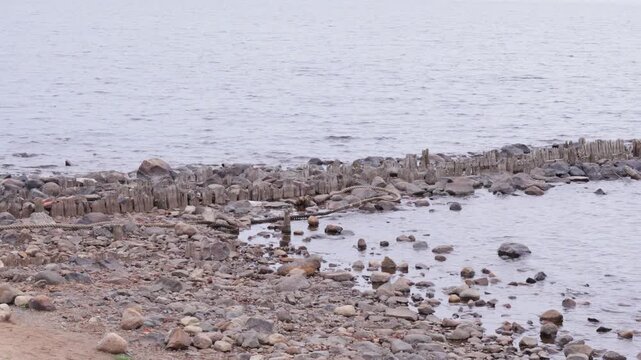 Remnants of old wooden pier against the calm waters