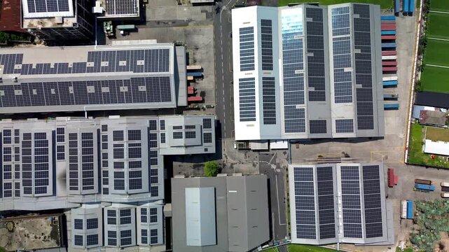 Aerial View of Industrial Buildings with Rooftop Solar Panel Infrastructure and Renewable Energy Systems