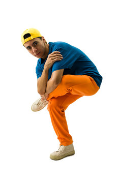 Young man performing street dance moves, crouching in a dynamic hip hop style, wearing colorful urban attire