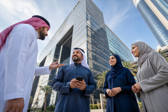 Middle Eastern businesspeople, modern office building, teamwork, outdoor meeting, smiling group