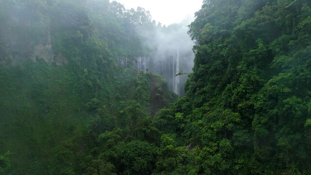Cinematic Drone Shot of Tumpak Sewu Waterfall with Floating Clouds &ndash; Java Island Indonesia