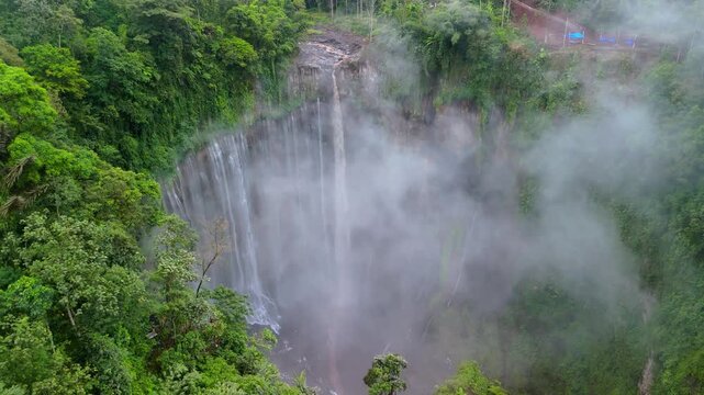 Scenic Drone View of Tumpak Sewu Waterfall with Atmospheric Clouds &ndash; Java Island Indonesia