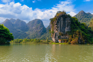 Scenic limestone karsts and tranquil river in Ninh Binh, Tam Coc National Park Vietnam
